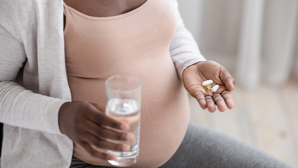 Pregnant woman taking prenatal vitamins.